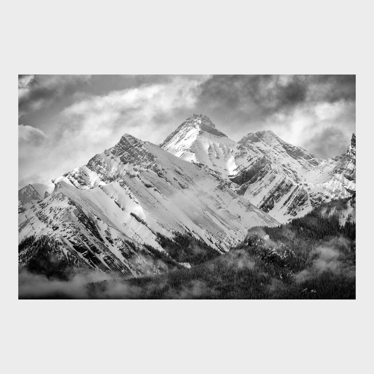 Black and white photograph of snow-capped mountains with clouds in the sky, Misty Mountains, Mount Murray, Kananaskis Country, Alberta, Canada, Rocky Mountains