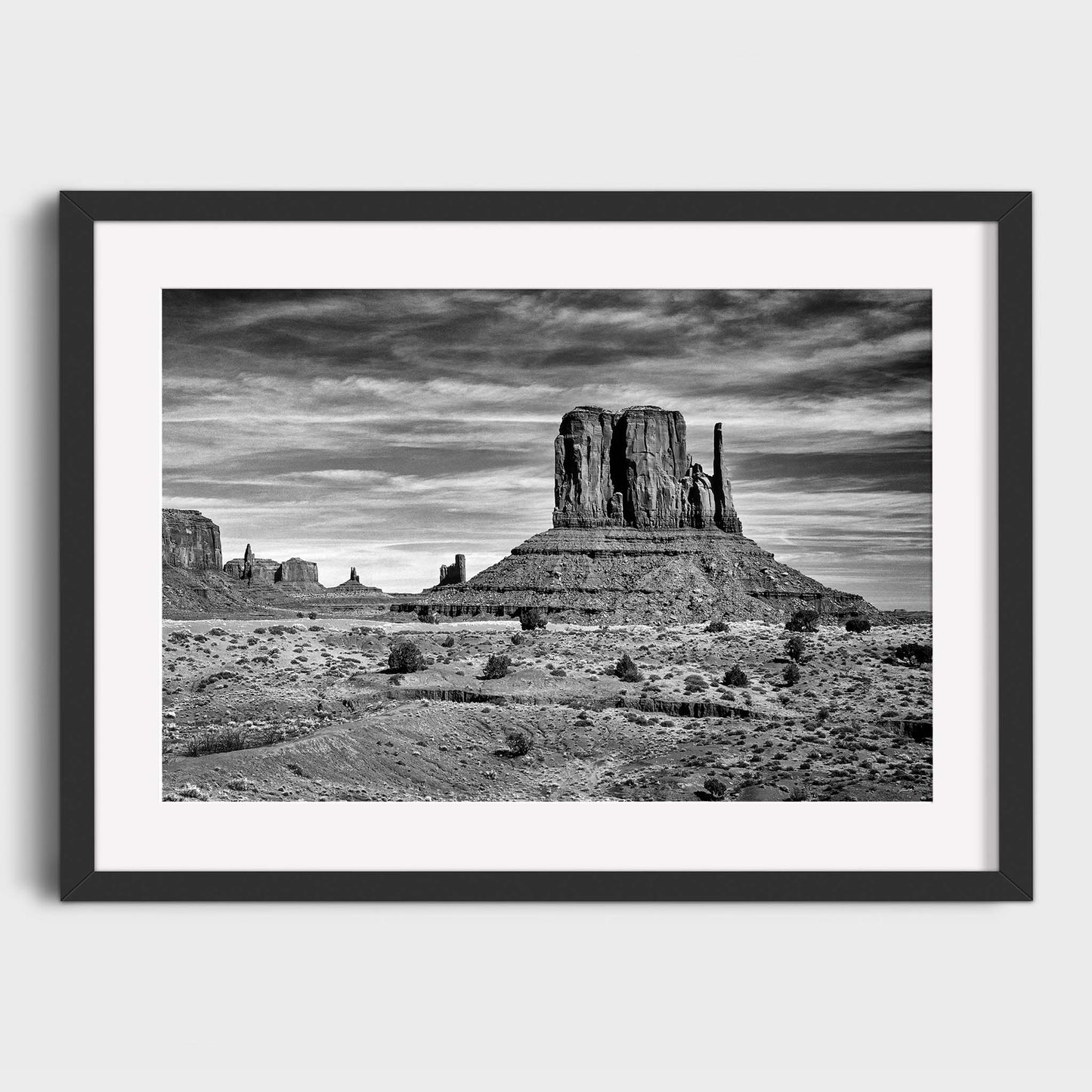 Framed black and white photograph of Monument Valley landscape