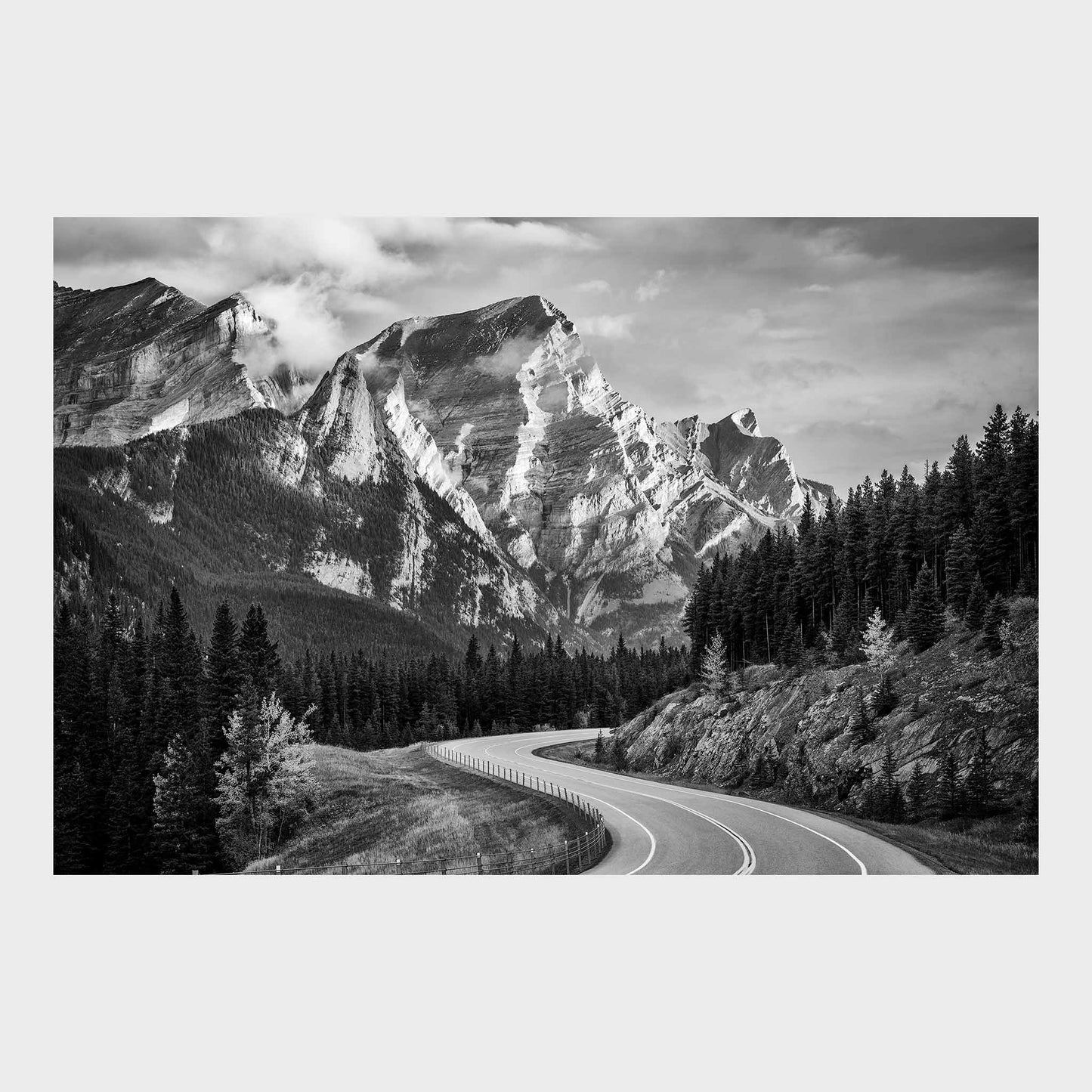 Winding road through a forest with snow-capped mountains in the background. Kananaskis Country, Fine Art Photography, Dermot O'Kane, Rocky Mountains, Alberta, Canada