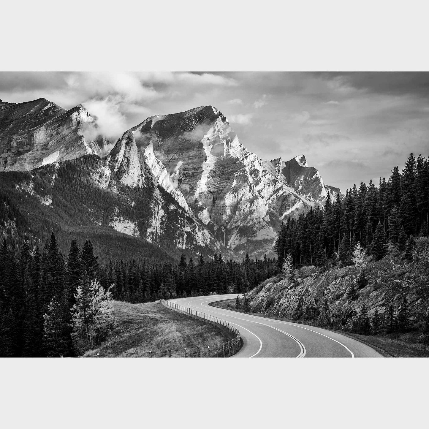 Winding road through a forest with snow-capped mountains in the background. Kananaskis Country, Fine Art Photography, Dermot O'Kane, Rocky Mountains, Alberta, Canada