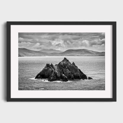 Framed black and white photograph of a rocky island in the ocean with mountains in the background. Little Skellig, Co. Kerry, Ireland, Luke Skywalker, Star Wars Island, Beautiful fine art landscape photography wall art prints for sale. Dermot O'Kane