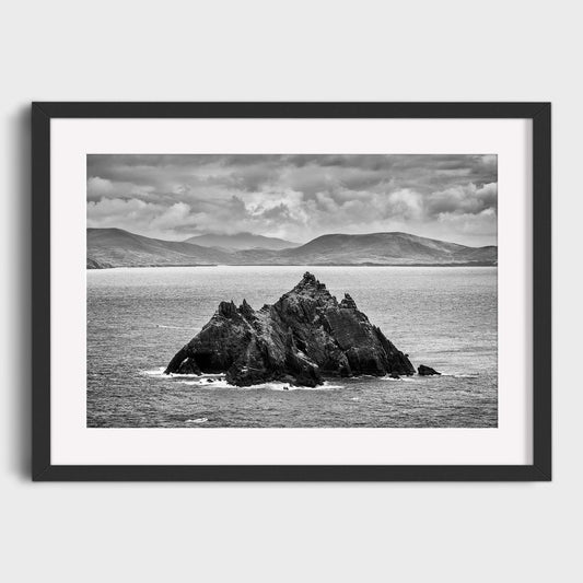 Framed black and white photograph of a rocky island in the ocean with mountains in the background. Little Skellig, Co. Kerry, Ireland, Luke Skywalker, Star Wars Island, Beautiful fine art landscape photography wall art prints for sale. Dermot O'Kane