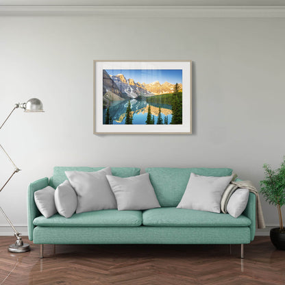 Teal sofa with gray pillows in a living room with a framed mountain landscape picture on the wall. Moraine Lake, Banff National Park, Alberta, Canada, Beautiful fine art landscape photography wall art prints for sale. Dermot O'Kane