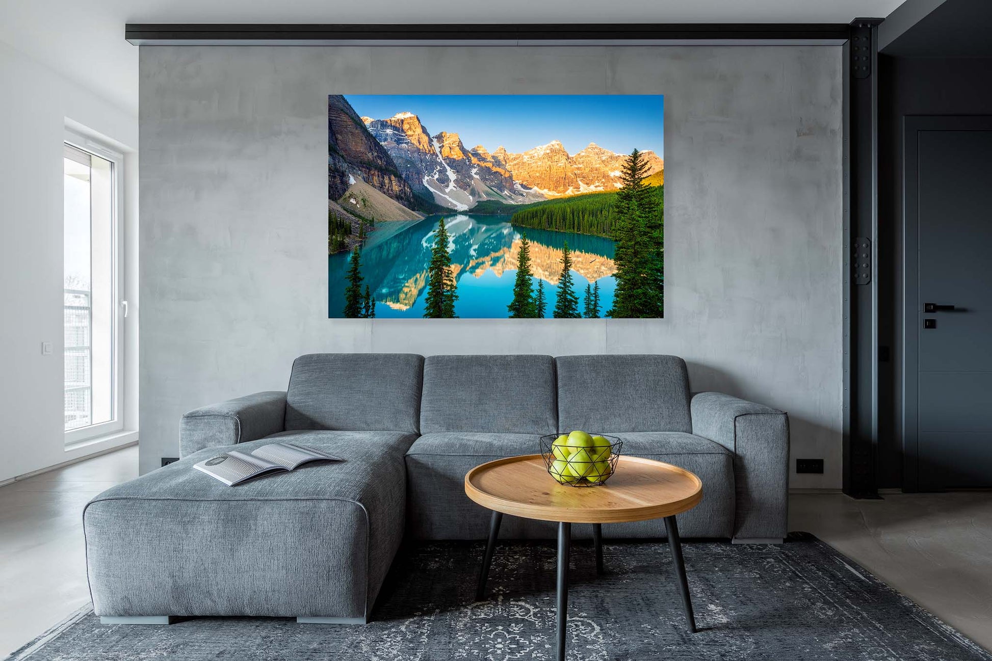 Gray sofa in a living room with a large mountain landscape painting on the wall. Moraine Lake, Banff National Park, Alberta, Beautiful fine art landscape photography wall art limited edition prints for sale. Dermot O'Kane.