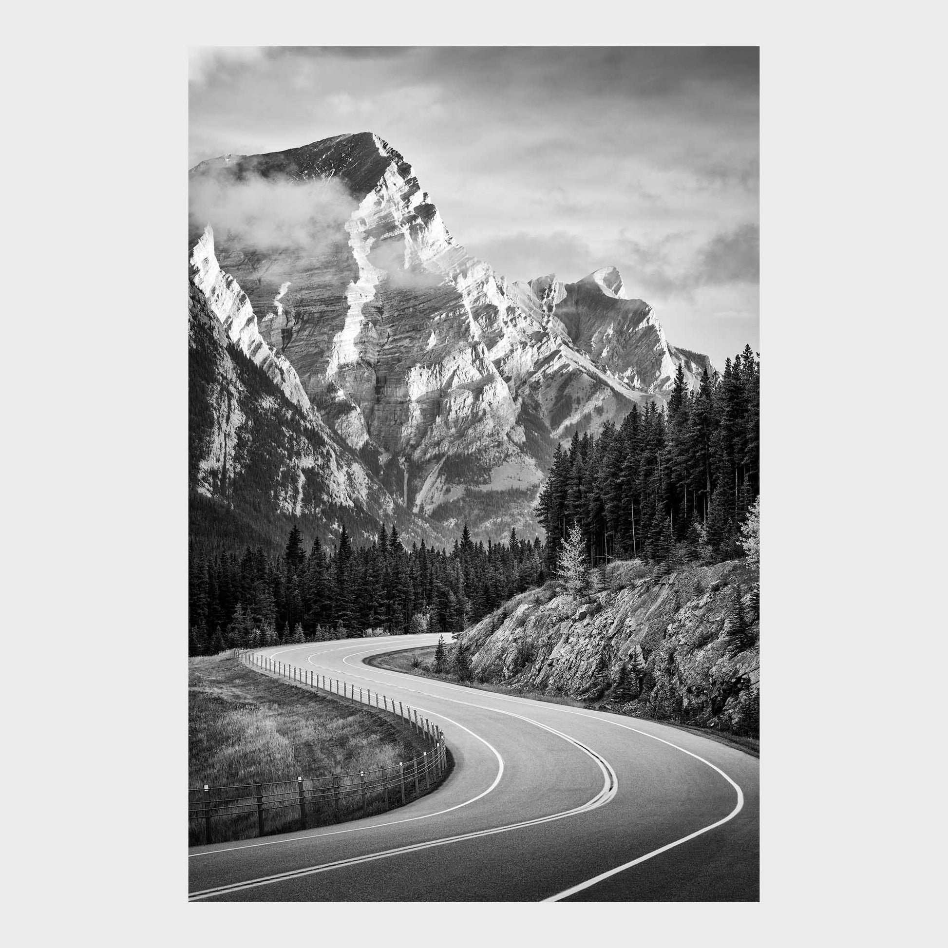 Winding road through a forest with snow-capped mountains in the background. Kananaskis Country, Fine Art Photography, Dermot O'Kane, Rocky Mountains, Alberta, Canada
