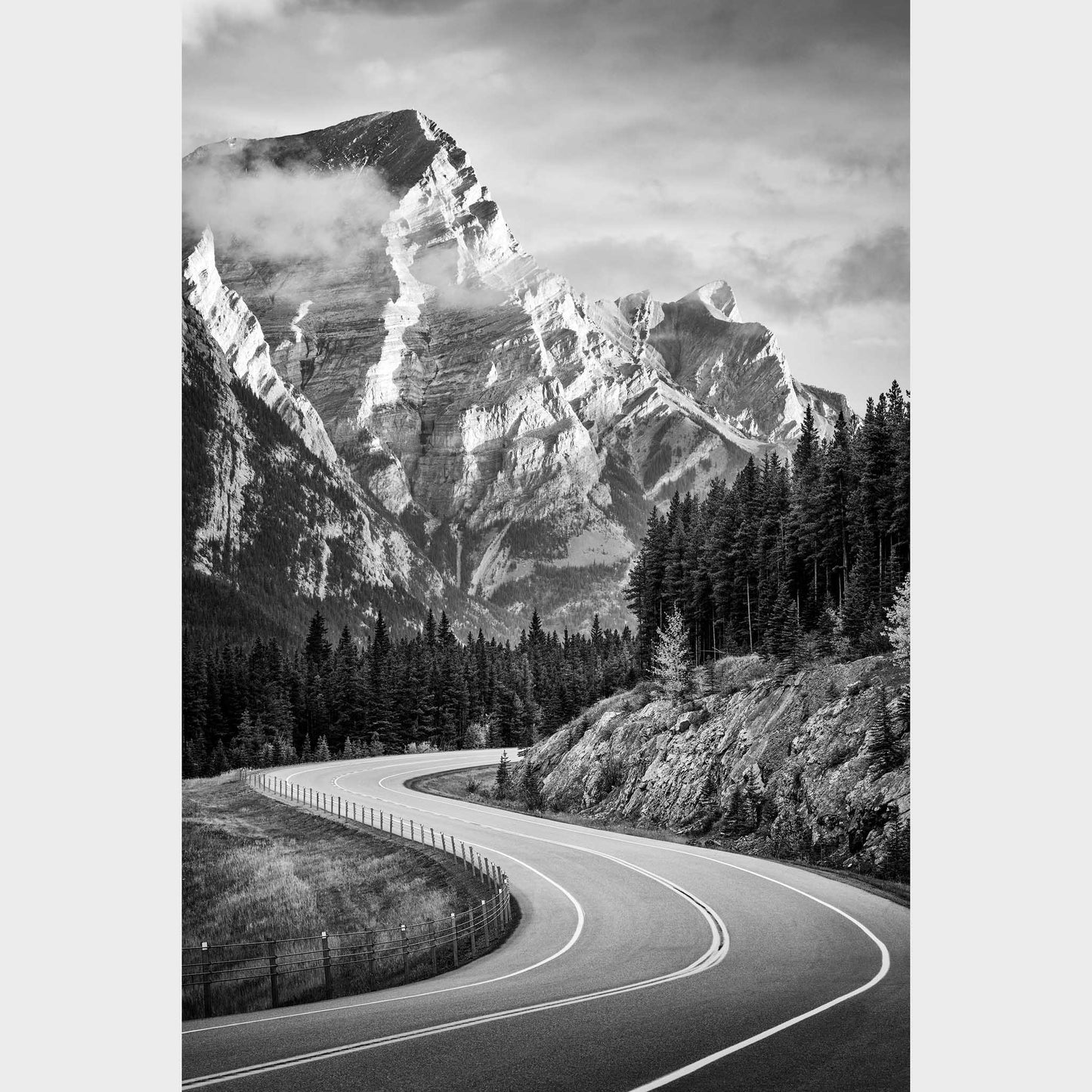 Winding road through a forest with snow-capped mountains in the background. Kananaskis Country, Fine Art Photography, Dermot O'Kane, Rocky Mountains, Alberta, Canada