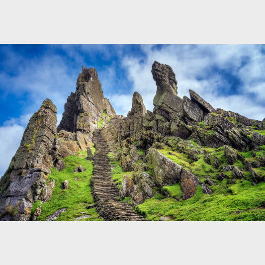 Rocky landscape with a staircase leading up to a craggy peak under a blue sky. Skellig Michael Steps, Co. Kerry, Ireland, Beautiful fine art landscape photography wall art limited edition prints for sale.