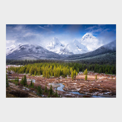 Snow-capped mountains with a forest and a river in the foreground. Spray Valley, Kananaskis Country, Alberta, Canada, Rocky Mountains